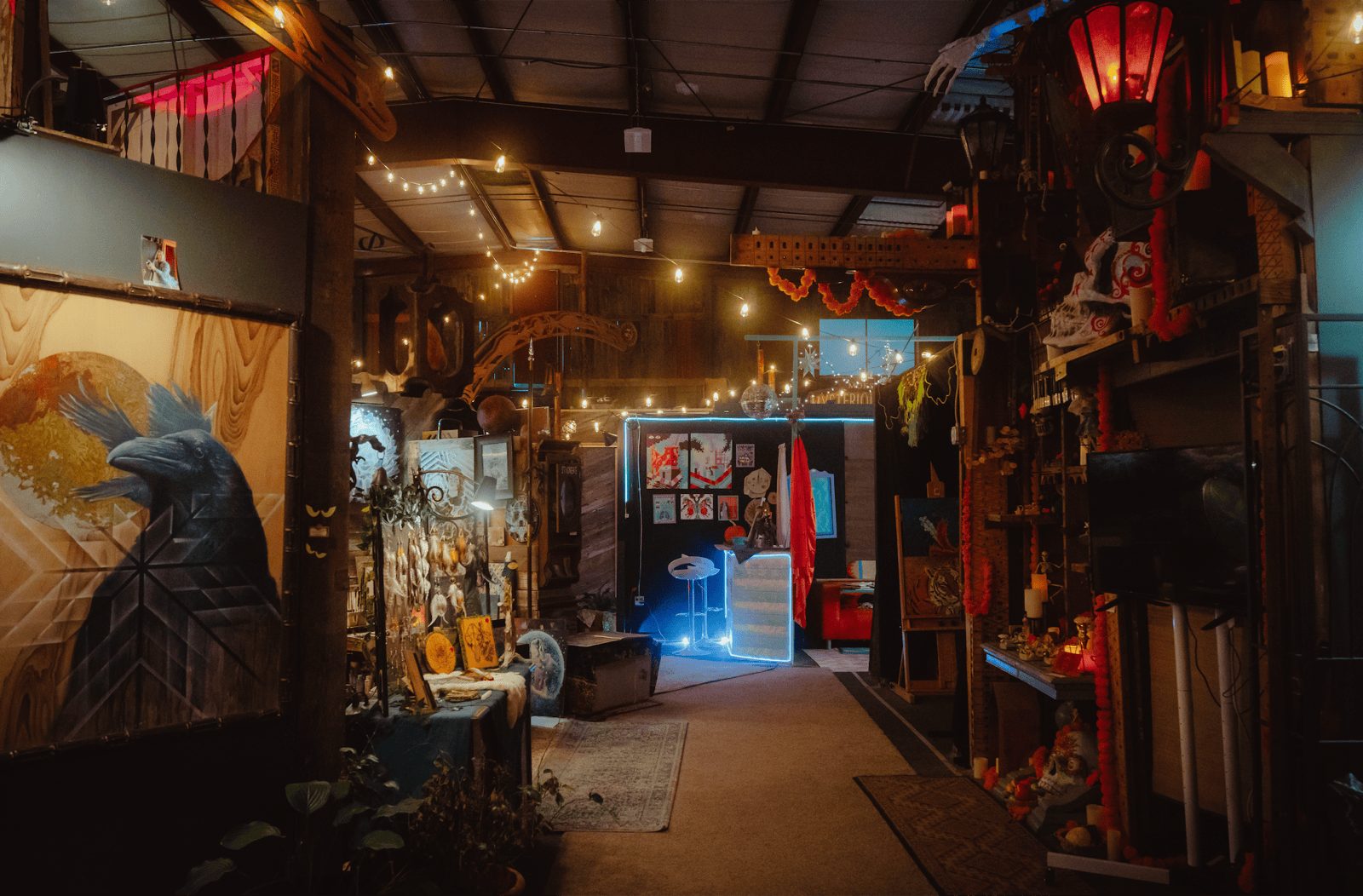 A corridor of artist studios at The Haven strung with warm lights