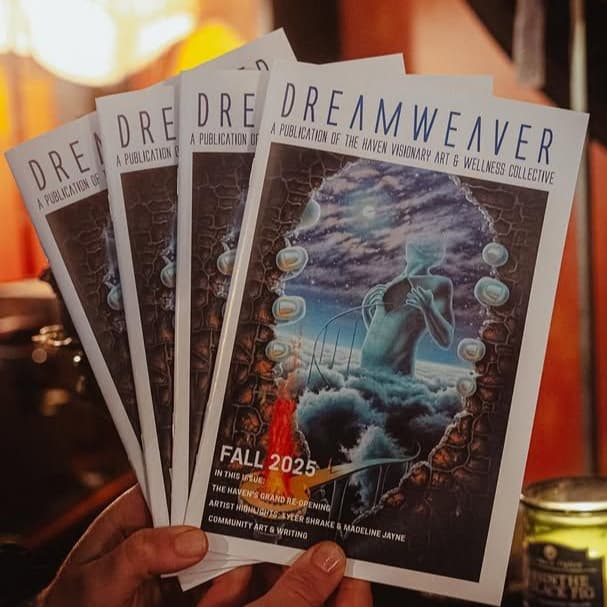 Copies of Dreamweaver, The Haven's quarterly publication, held in a hand